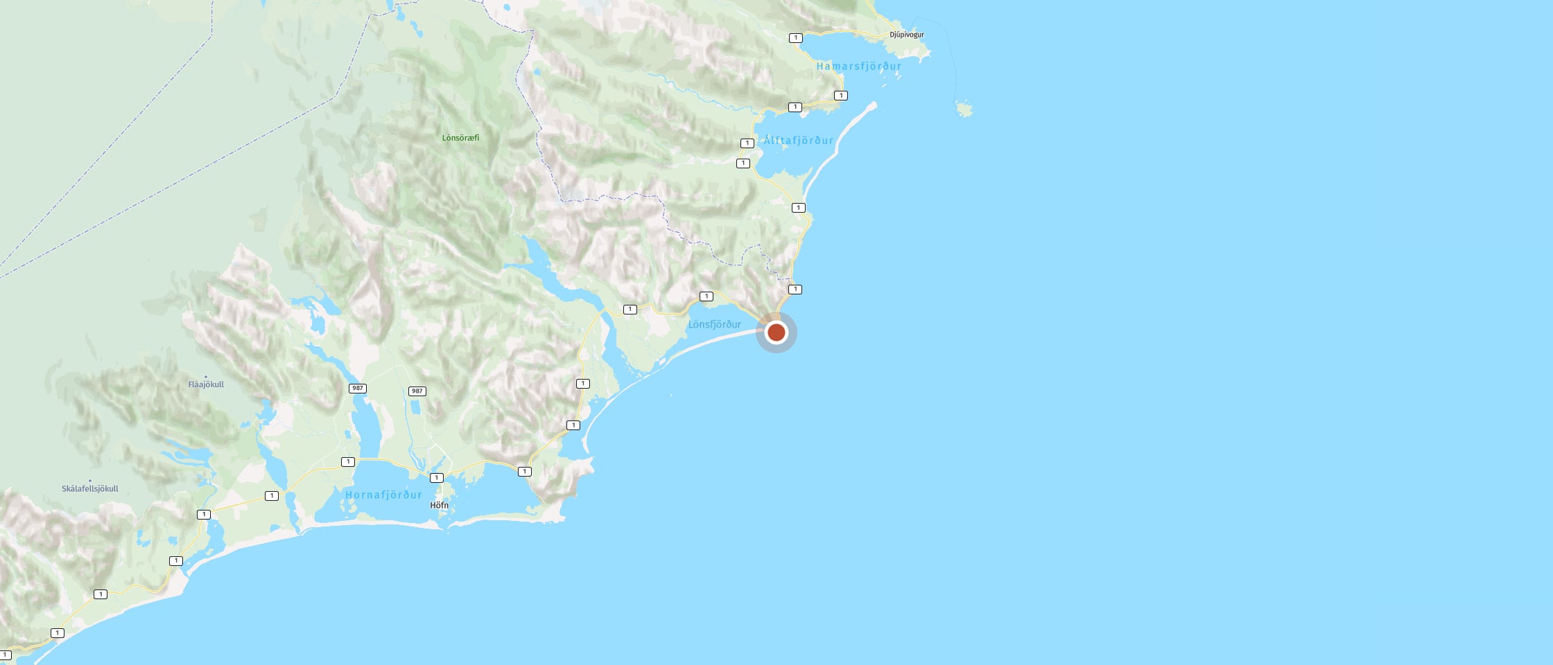 Map: Photograph the orange Hvalnes lighthouse on the coast
